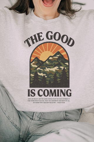 A woman wearing The Good Is Coming Design with mountain
