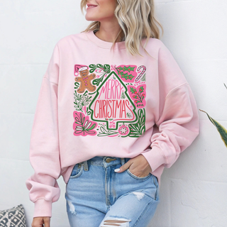 Person wearing a pink sweatshirt with a 'Merry Christmas' design against a white background