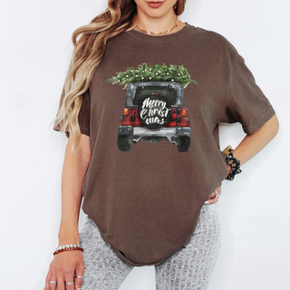 Person wearing a brown t-shirt with a Christmas truck graphic on a white background