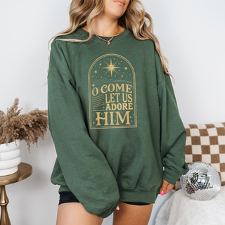 Person wearing a green sweatshirt with gold text in a decorative arch design.