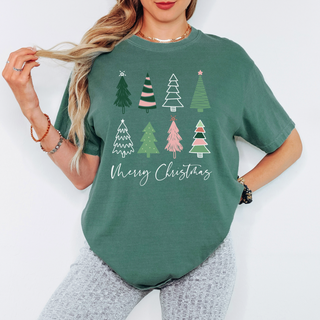 Person wearing a green t-shirt with Christmas tree designs and 'Merry Christmas' text on a white background