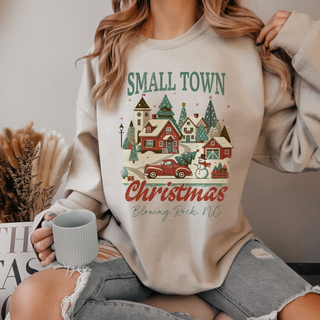 Person wearing a 'Small Town Christmas' themed sweatshirt with a festive design.